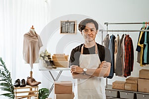 Proud young online ecommerce shop owner standing at his office