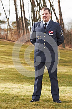 Proudly displaying his medals. Full length portrait of a high ranking military official standing at ease.