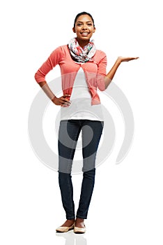 Proudly presenting a product. Full body portrait of a pretty young woman displaying your product against a white