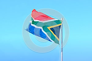 Proudly South African flag on blue sky background