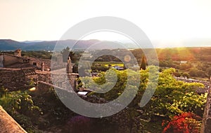 Provencal garden at sunset, retro style picture. Village of Mirmande, France