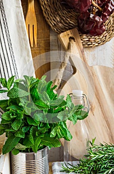 Provence style kitchen interior, white board wall, glass bottle, rattan coaster, linen towel, utensils