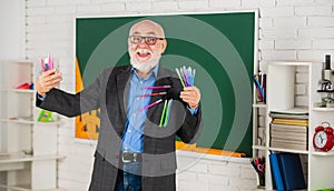 Provide customised education to deliver right content at right time. Senior intelligent man teacher at chalkboard