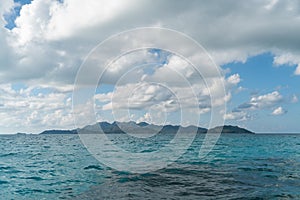 Providencia island seen with cloudy blue sky and blue water