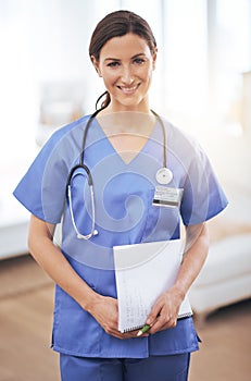 She provides the best of care to her patients. Portrait of a smiling nursing holding a medical chart.