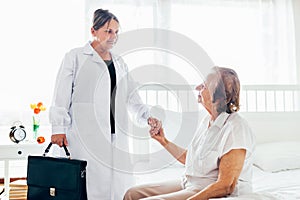 Providing care for elderly. Doctor visiting elderly patient at home.