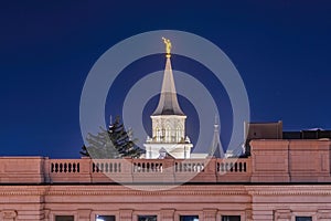Provo City Center Temple with statue of angel and spire against blue evening sky