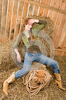 Provocative position young cowgirl on hay