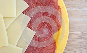 Provolone cheese slices and genoa salami on tabletop
