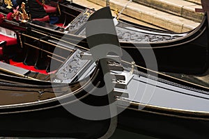 Prow of gondola moored on canal - Venice, Venezia