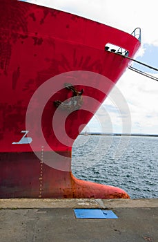 Prow of an old red freighter at the port photo