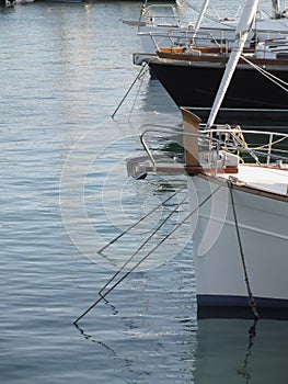 Prows of luxury sailboats moored in the harbor in Marina di Pisa, Tuscany, Italy