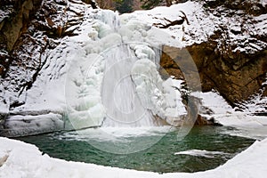 Pruncea waterfall at winter, on Casoca river, Romania