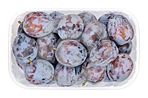 Ripe prune plums, fresh freestone fruits in a clear plastic container