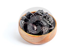 Prunes inside wooden bowl