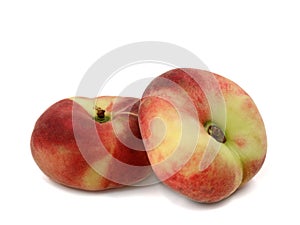 Prunus Persica, two flat peaches isolated on a white background photo