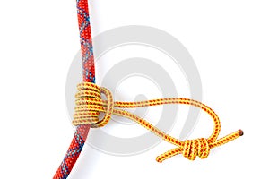 Prusik Knot or Triple Sliding Hitch formed with a 5mm yellow Prusik loop around a 9.8mm red climbing rope. photo