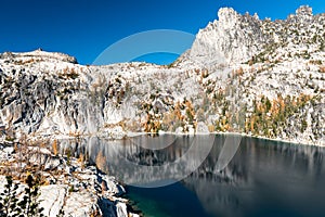 Prusik peak reflecting in Lake Viviane in autumn