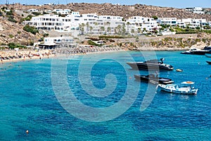 Psarou beach in Mykonos Greece blue sea, umbrella and luxury beach services