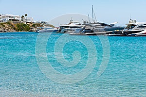 Psarou beach in Mykonos Greece blue sea, umbrella and luxury beach services