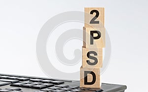 PSD2 - acronym on wooden blocks with letters, Payment Service Directive 2 payment and commerce concept, front view on white