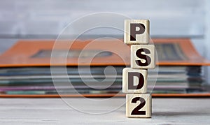 PSD2 - word on wooden cubes on the background of a folder with documents
