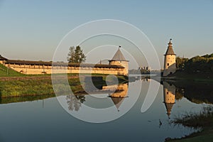 Pskov, Russia, September 11, 2023. Reflection in the water of the fortress towers at dawn.