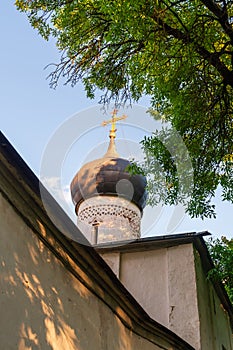 Pskov, Russia, September 6, 2023. The dome of an old church and a fragment of a wall.