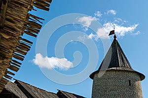 Pskov, Russia, September 6, 2023. Hip roof with a weather vane of the old Kremlin tower.