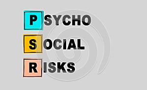 PSR - PsychoSocial Risks abbreviation on gray background. Business concept. Multi colored square sticky notes on gray background,
