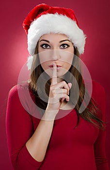 Psst - woman with santa hat photo