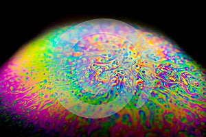 Psychedelic abstract planet from soap bubble, Light refraction on a soap bubble, Macro Close Up moving particles Rainbow colors on