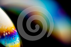 Psychedelic abstract planet from soap bubble, Light refraction on a soap bubble, Macro Close Up moving particles Rainbow colors on