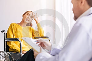Psychiatrist doctor collect data talk with patient on wheelchair for mental care health problems check followup in hospital clinic