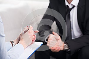 Psychiatrist examining a male patient photo