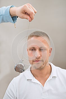 Psychiatrist Hypnotizing Patient With Pendulum photo