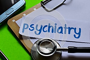 Psychiatry on Healthcare concept with green background photo
