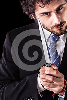 Psycho businessman with kitchen knife