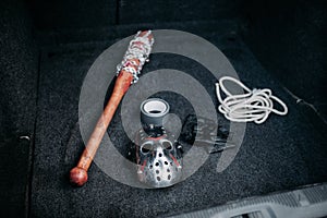 Psycho man instruments in opened car trunk, maniac