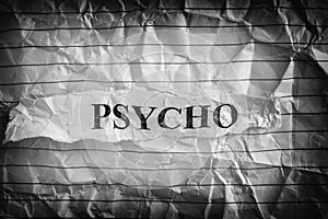 Psycho. Torn piece of paper with the word Psycho