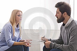 Psychoanalyst listening to depressed woman talking about her troubles