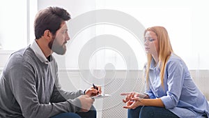 Psychoanalyst listening to depressed woman talking about her troubles