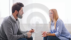 Psychoanalyst listening to depressed woman talking about her troubles photo