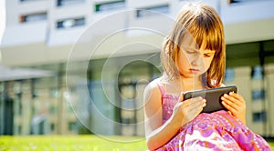 Psychological image of cute little girl addicted to likes: Social networks feeds her neediness. Portrait of nervous child with photo