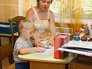 Psychologist and a child with Down syndrome perform