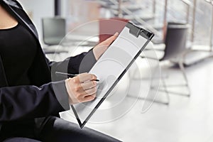 Psychologist with clipboard prepared for group therapy