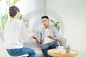 Psychologist consulting and psychological therapy session. Man in stress emotionally telling about his depression and problems to