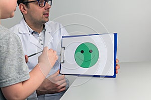 Psychologist counceling child in the cabinet.