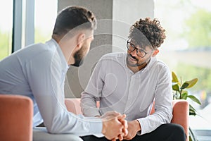 Psychologist listening to patient talking about problems during therapy session