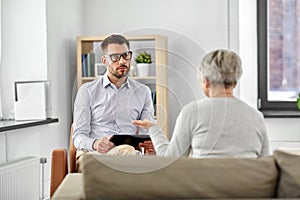 Psychologist listening to senior woman patient